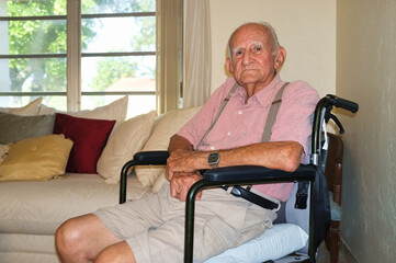Elderly eighty plus year old man in a wheelchair in a home setting