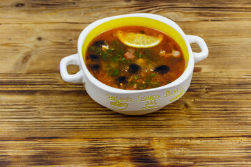Traditional russian hodgepodge soup on a wooden table