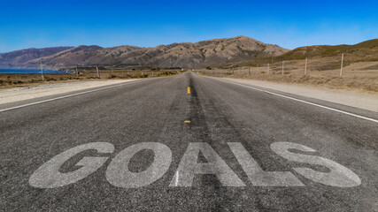 Goals written on highway road to the mountain