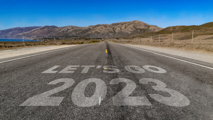 Let's Go 2023 written on highway road to the mountain
