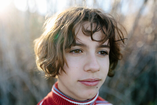 Closeup Of A Teen Girl With Short Hair Looking Off In A Distance