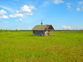 wooden chapel on a marshy lake holy place