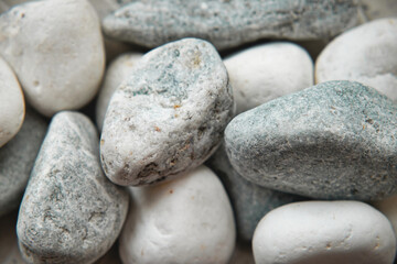 Fototapeta na wymiar Abstract background with dry stones. Closeup of white stones.