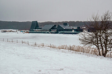 Photo in a nature park with a frozen lake and an administrative and entertainment building