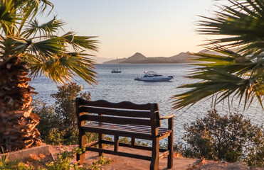 A beautiful place to relax with a wonderful view of the sea at sunset. Mediterranean coastline with islands, mountains and yachts. Summer vacation concept