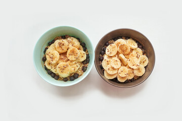 Healthy breakfast. Top view. Oatmeal with banana and flax seeds at bowl. Berry in plate. Organic meal recipe. Vegan cook. Minimalism granola. Hot porrigde with fruit