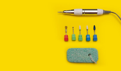Nail tool. Cutters for hardware manicure. Accessories and nail tool on yellow background. Milling...