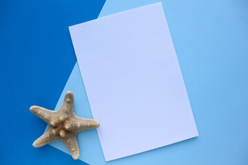 postcard mockup. blank white card with kraft brown paper envelope and seashells   