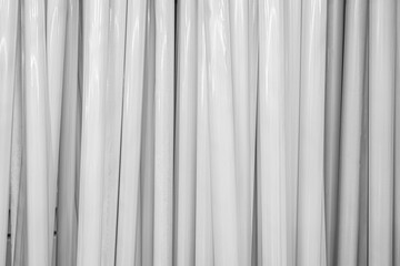 Obraz premium abstract background of a heap of white plastic curtain rods in a store