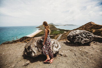 Tween girl looks at the view of St Kitts and Nevis mountains