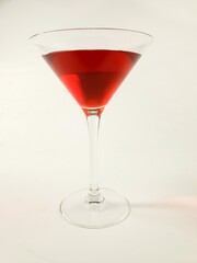 wine glass with red martini on white background