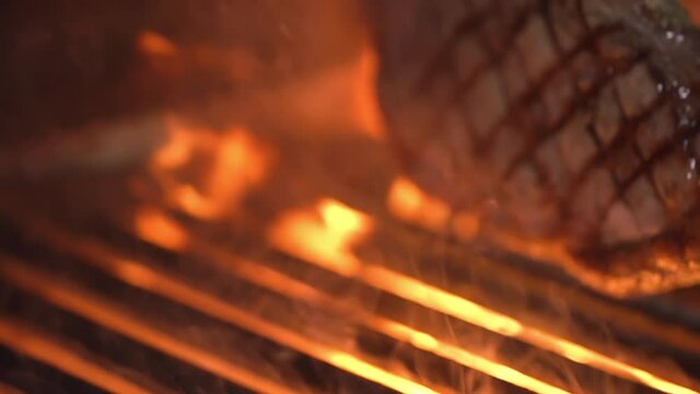 Juicy steak Tibon on the macro plan is turned to the other side. And the frame shows a beautiful grill on the meat