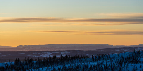 View to the westward mountains seen from the Totenåsen Hills, Norway, at evening in winter.