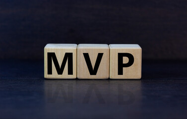 MVP, minimum viable product symbol. Wooden cubes with the word MVP, minimum viable product....
