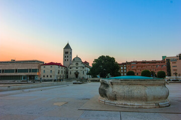 Zadar, Croatia / 31st July 2020: St. Mary church (sveta Marija) and stone well at Forum square, famous landmarks in Zadar