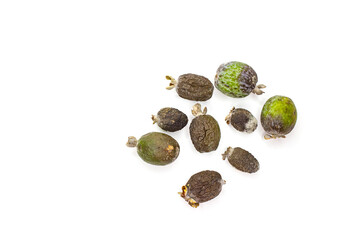 Over-ripe, spoiled feijoa fruit. Those that have begun to rot, they have blackness, mold, and fungus on them. The process of spoilage, rotting of green fruits. White background.