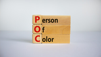 POC, person of color symbol. Wooden cubes and blocks with words POC, person of color. Beautiful white background. Business and POC, person of color concept, copy space.