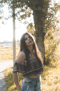 Beautiful Asian Girl Wearing A Crop Top And A Jean Skirt Looking At The Camera At The Park