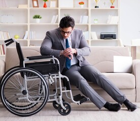 Obraz na płótnie Canvas Dsabled businessman on wheelchair working home