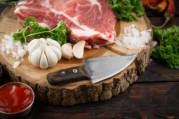 Raw meat with spices in a composition with kitchen accessories.