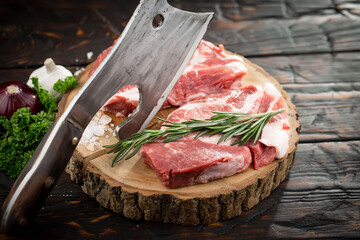Raw meat with spices in a composition with kitchen accessories.