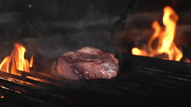 A raw piece of meat is placed on the grill