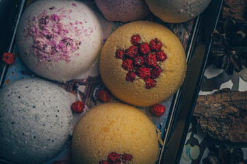 Handmade bath bombs with dry berries and flower petals.