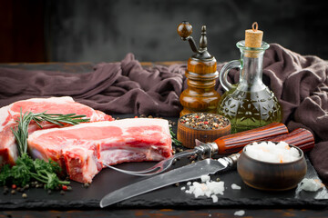 Fototapeta na wymiar Raw meat with spices in a composition with kitchen accessories.