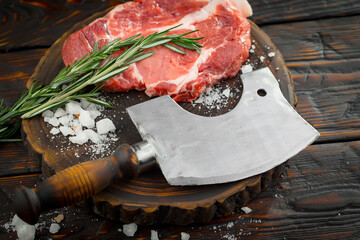 Raw meat with spices in a composition with kitchen accessories.