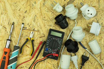 Electrical objects and tools are spread out on the table with empty space for text (copy the space)