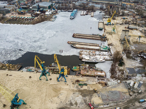 Frozen cargo port bay. Aerial drone view. Winter cloudy morning. - Powered by Adobe