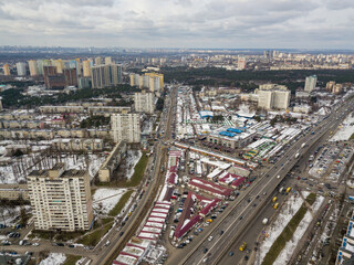 Kyiv road junction in light snow. Aerial drone view. Winter cloudy morning.