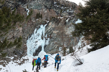 Group hiking to icy waterfall, Cogne, Aosta Valley, Italy