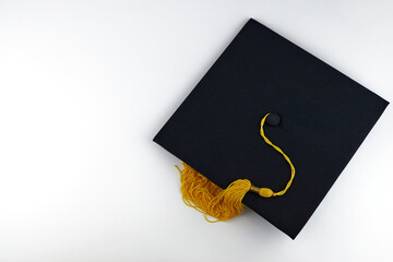 Black graduation cap on a white background, copy space. Academic hat, graduation concept