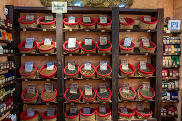 interior view of a tea shop with herb and spices and many sorts of teas in baskets
