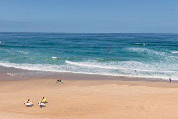 Surfers walking on the beach, plage des casernes, seignosse, landes, france