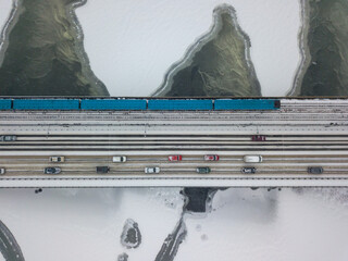 One train on Kiev metro bridge across the frozen Dnieper river. Textured pattern on ice. Aerial...
