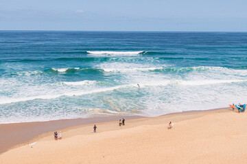 Aerial shot of the beach with surfers, seignosse, landes, france