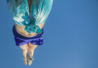 Acrobat do a handstand wearing cetim clothes during Rio Carnival