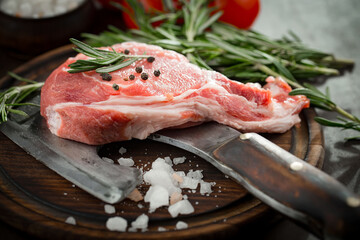 Raw meat with spices in a composition with kitchen accessories.