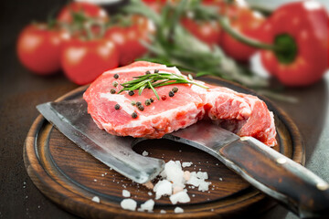 Raw meat with spices in a composition with kitchen accessories.