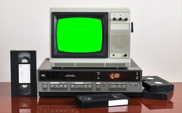 Old silver vintage TV with green screen to add new images to the screen, VCR on wallpaper background.	