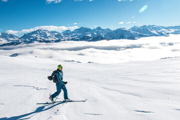 Fototapeta na wymiar Ski touring over sea of clouds, Beaufortain, French Alps, France