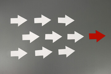Fototapeta premium Leadership concept. Red leader arrow leading team forward