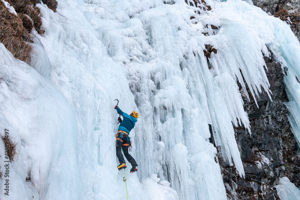 Wall mural Ice climber on frozen waterfall, Cogne, Aosta Valley, Italy