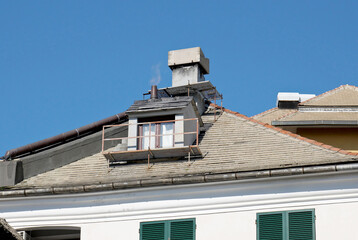 Fototapeta na wymiar House with chimney and smoke 