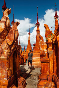Man walking by stupas at Shwe Indein Pagoda