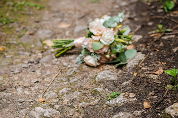 the bride's beckett with wedding rings lies on the road