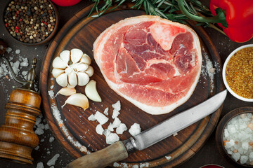 Raw meat with spices in a composition with kitchen accessories.