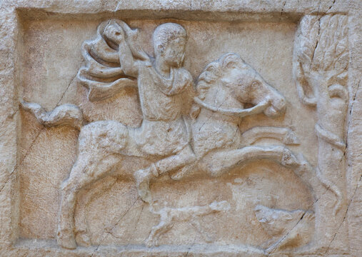Ancient bas-relief on funerary stele from Kerameikos in Athens, Greece depicting rider in hunting scene. Gravestone of Attica-type